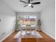 Dining room with modern table and chairs, overlooking a landscaped yard through a large window at 2432 Keene Park Dr, Largo, FL 33771