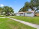 Well-maintained single-story home showcasing a neatly kept lawn and a welcoming exterior on a sunny day at 2432 Keene Park Dr, Largo, FL 33771