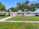 Charming single-story home with a well-manicured lawn and a bright, inviting exterior under a clear blue sky at 2432 Keene Park Dr, Largo, FL 33771