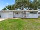 Charming single-story home with a well-maintained lawn and attached garage at 2432 Keene Park Dr, Largo, FL 33771