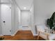 Hallway featuring wood flooring, a seat, and white paint at 2432 Keene Park Dr, Largo, FL 33771