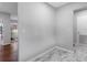 Empty hallway provides an open view of the hardwood floors and the marble floors at 2432 Keene Park Dr, Largo, FL 33771