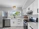 Stylish kitchen boasts quartz counters, stainless steel appliances and ample cabinetry at 2432 Keene Park Dr, Largo, FL 33771