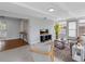 Open-concept living room features a blend of tile and wood flooring with natural light at 2432 Keene Park Dr, Largo, FL 33771