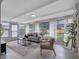 Bright sunroom features a seating area and large windows providing an abundance of natural light at 2432 Keene Park Dr, Largo, FL 33771