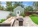 Charming backyard featuring a stone patio with lounge seating, lush greenery, and a tranquil ambiance at 2439 6Th N Ave, St Petersburg, FL 33713