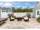 Backyard patio with outdoor seating, lush greenery, and a fire pit, perfect for relaxing and entertaining at 2439 6Th N Ave, St Petersburg, FL 33713