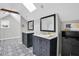 Bathroom featuring dual vanities, stylish mirrors, and patterned tile flooring at 2439 6Th N Ave, St Petersburg, FL 33713