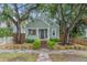 Craftsman home exterior features mature trees, professional landscaping, and covered front porch at 2439 6Th N Ave, St Petersburg, FL 33713