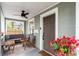 Inviting front porch includes neutral furnishings, stylish ceiling fan and attractive door at 2439 6Th N Ave, St Petersburg, FL 33713