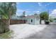 Detached garage with a gravel driveway, offering ample parking and storage space at 2439 6Th N Ave, St Petersburg, FL 33713