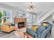 Spacious living room features a fireplace, hardwood floors, and staircase to the second level at 2439 6Th N Ave, St Petersburg, FL 33713