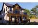 Stylish two-story house with a wood-accented balcony and sleek architectural design, enhanced by landscape at 2501 Quincy S St, St Petersburg, FL 33711
