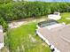 Expansive backyard features an enclosed pool, storage buildings, mature trees, and a well-maintained lawn at 25555 Oaks Blvd, Land O Lakes, FL 34639
