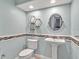 Stylish powder room with modern fixtures, decorative accents, and tiled walls at 25555 Oaks Blvd, Land O Lakes, FL 34639