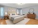 Comfortable bedroom featuring hardwood floors, natural light, and tasteful decor at 25555 Oaks Blvd, Land O Lakes, FL 34639