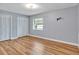 Well-lit bedroom with laminate floors, neutral paint, and spacious double closets for ample storage solutions at 25555 Oaks Blvd, Land O Lakes, FL 34639