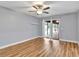 Bright bedroom with hardwood floors and sliding glass doors opening to a covered patio and backyard at 25555 Oaks Blvd, Land O Lakes, FL 34639