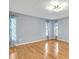 Bright bedroom featuring hardwood floors, natural light, and decorative curtains at 25555 Oaks Blvd, Land O Lakes, FL 34639