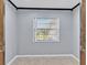 Empty bedroom with natural light coming through the window and neutral walls at 25555 Oaks Blvd, Land O Lakes, FL 34639