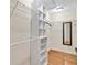 Spacious walk-in closet with custom shelving, ample storage, and natural light at 25555 Oaks Blvd, Land O Lakes, FL 34639