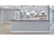 Open kitchen features stainless steel appliances, granite countertops, and modern pendant lighting at 25555 Oaks Blvd, Land O Lakes, FL 34639