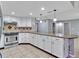 Stylish kitchen with stainless steel appliances, granite countertops, and custom white cabinets at 25555 Oaks Blvd, Land O Lakes, FL 34639