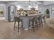 Modern kitchen boasts an island with seating, stainless steel appliances, and pendant lighting at 25555 Oaks Blvd, Land O Lakes, FL 34639