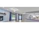 Living space with fireplace, pool access, and kitchen area with stainless appliances at 25555 Oaks Blvd, Land O Lakes, FL 34639