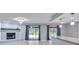 Open living area with fireplace, access to patio, and kitchen with granite countertops at 25555 Oaks Blvd, Land O Lakes, FL 34639