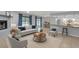 Stylishly furnished living room connects to the kitchen and features a cozy fireplace at 25555 Oaks Blvd, Land O Lakes, FL 34639