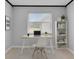 Bright home office featuring a modern desk, chair, and built-in shelving with natural light from a window at 25555 Oaks Blvd, Land O Lakes, FL 34639