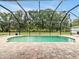 Inviting pool area surrounded by a screened enclosure and a brick paver patio at 25555 Oaks Blvd, Land O Lakes, FL 34639