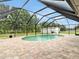 Inviting pool area surrounded by a screened enclosure and a brick paver patio at 25555 Oaks Blvd, Land O Lakes, FL 34639