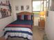 Comfortable bedroom with wood-look flooring, closet, and natural light at 2616 Cove Cay Dr # 104, Clearwater, FL 33760
