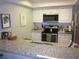 Well-lit kitchen featuring granite countertops and stainless steel appliances at 2616 Cove Cay Dr # 104, Clearwater, FL 33760