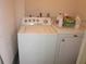 Bright laundry room equipped with a full-size white washer and dryer set at 2616 Cove Cay Dr # 104, Clearwater, FL 33760