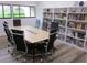Bright meeting room featuring a large table, rolling chairs, and well-stocked bookshelves at 2616 Cove Cay Dr # 104, Clearwater, FL 33760