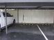 Covered parking with assigned spots and white wooden dividers in a rainstorm at 2616 Cove Cay Dr # 104, Clearwater, FL 33760