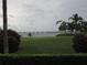 Waterfront view of bridge from green space with tropical trees and bushes at 2616 Cove Cay Dr # 104, Clearwater, FL 33760