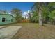 A spacious backyard featuring a concrete patio, paver patio and mature trees at 2931 23Rd N St, St Petersburg, FL 33713