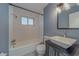 Well-lit bathroom with a clean, white tiled shower, modern vanity, and fixtures at 2931 23Rd N St, St Petersburg, FL 33713