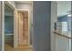 Hallway view featuring access to the bathroom and a partial view of the kitchen with stainless steel appliances at 2931 23Rd N St, St Petersburg, FL 33713