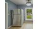 Kitchen area with new flooring and a stainless-steel refrigerator at 2931 23Rd N St, St Petersburg, FL 33713