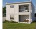 Modern home showcasing a balcony, a covered patio with a dining area, and an expansive backyard ideal for outdoor enjoyment at 2932 Fairfield S Ave, St Petersburg, FL 33712