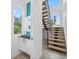 Modern entryway featuring a floating staircase, decorative mirror and sink vanity with a view at 2932 Fairfield S Ave, St Petersburg, FL 33712