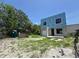 Under-construction modern home with framed openings for windows and garage, set against a clear blue sky and sparse greenery at 2932 Fairfield S Ave, St Petersburg, FL 33712