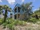 Exterior view of a house under construction with blue weatherproofing, showing a balcony and concrete block walls at 2932 Fairfield S Ave, St Petersburg, FL 33712