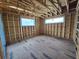 Unfinished room showcasing wood framework, floor, and window placement, awaiting personalized finishing touches at 2932 Fairfield S Ave, St Petersburg, FL 33712
