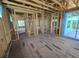 Unfinished room features wood framing, window and sliding glass door, floor for personalization at 2932 Fairfield S Ave, St Petersburg, FL 33712